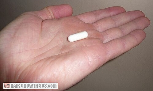 Capsule on palm of hand Capsule on palm of hand