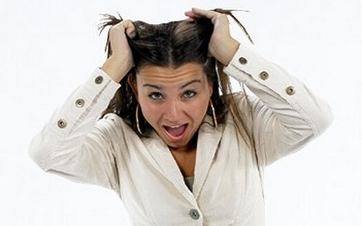 Lady looking stressed pulling at her hair